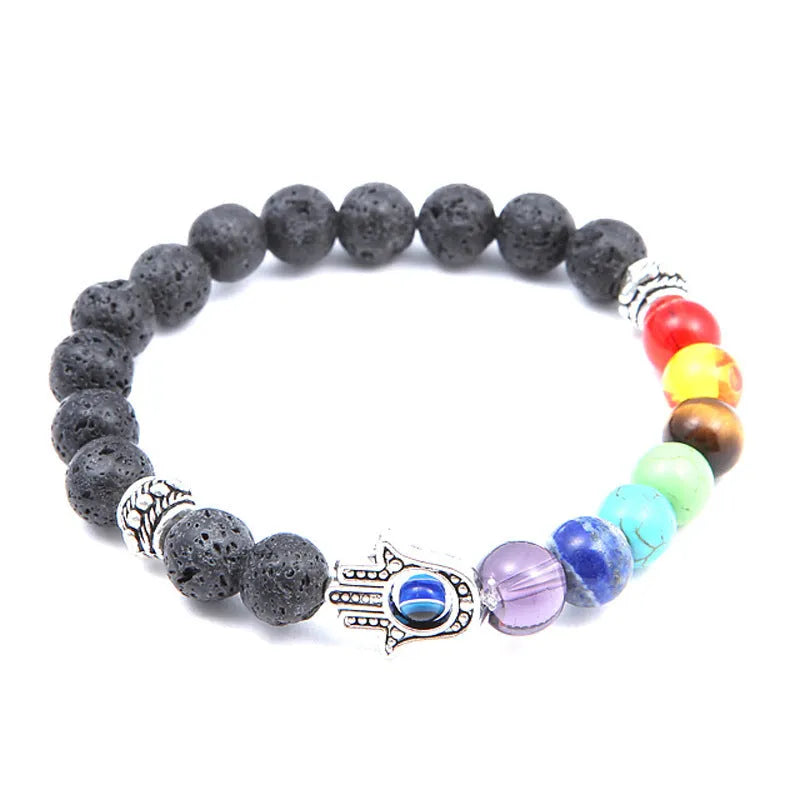 Volcanic rock and blue eyes palm seven chakra hand chain on a neutral background