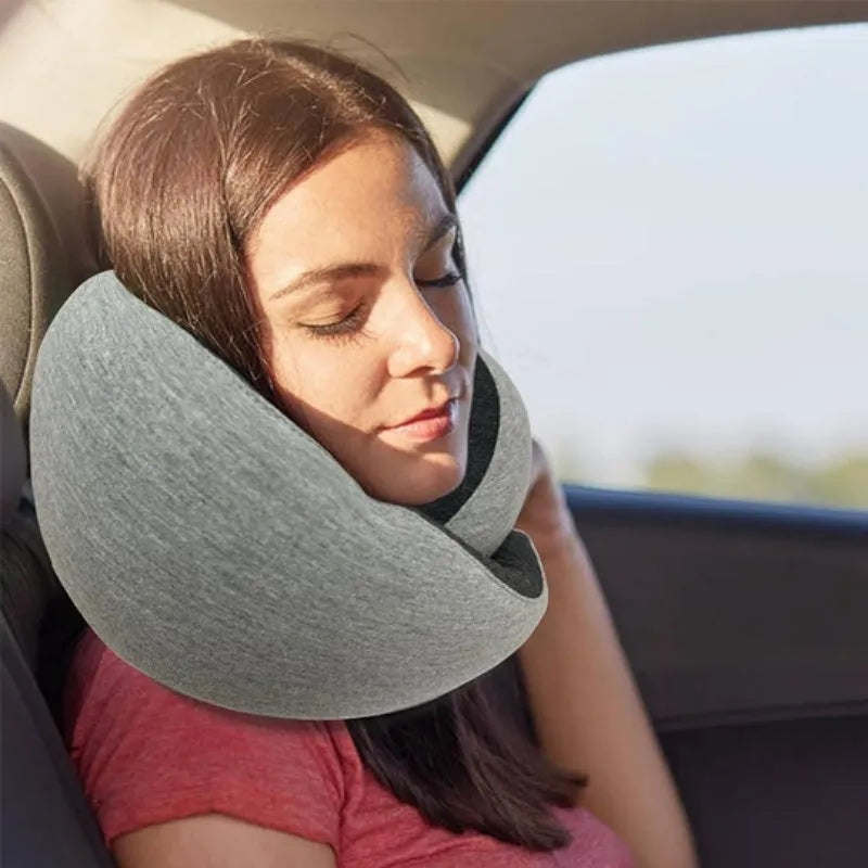 Navy blue U-shaped travel neck pillow with memory foam filling shown rolled for compact storage