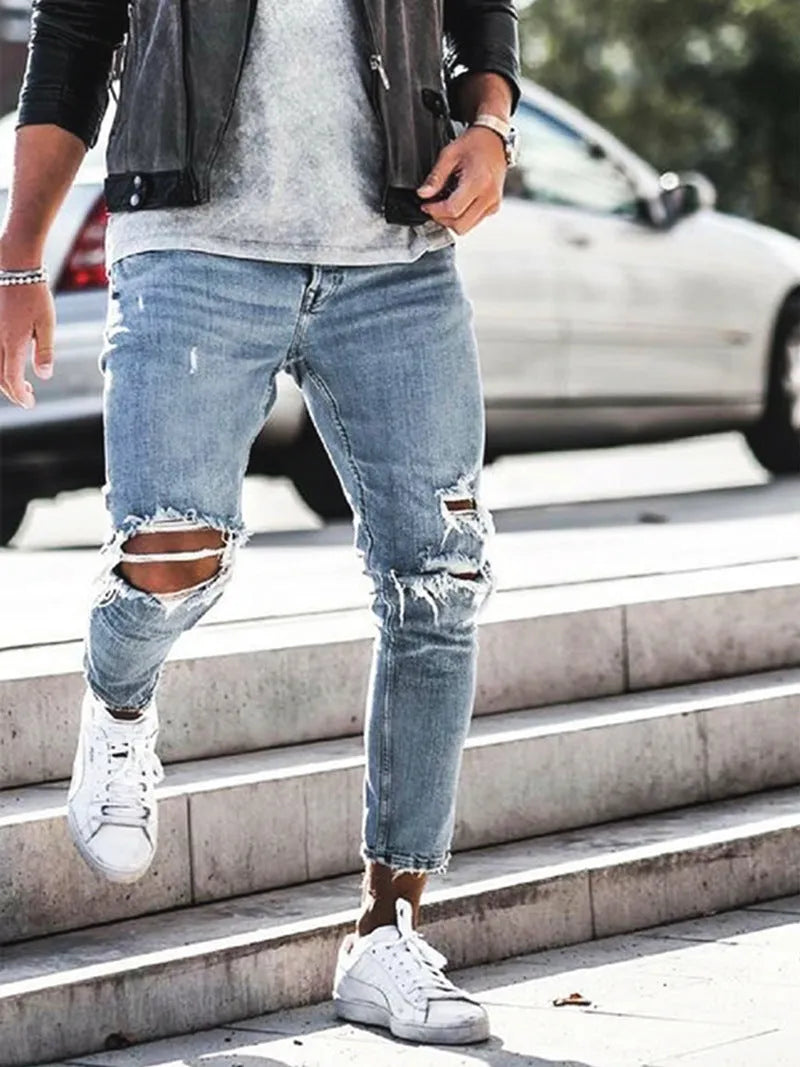 Men's light blue straight fit distressed jeans with embroidered details and zip fly
