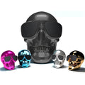 Skull-shaped wireless Bluetooth speaker with rechargeable battery showing front detail and colour options