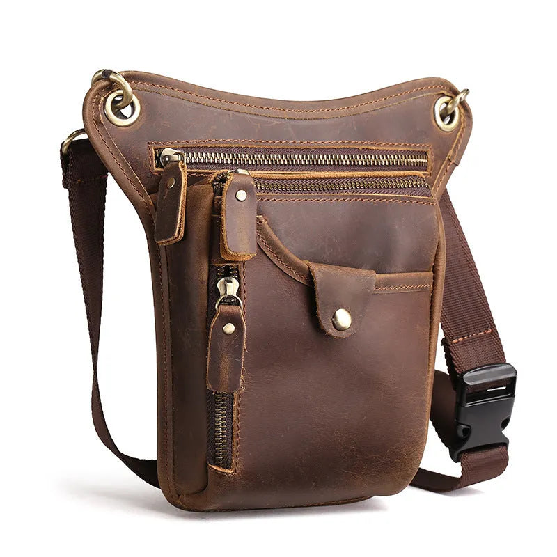 Men's brown Crazy Horse leather retro satchel bag with flap closure on a table.