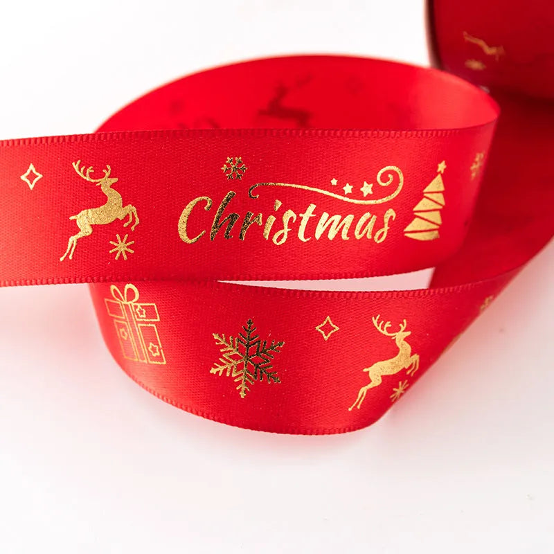 2.5cm Christmas polyester ribbon roll 22m in Ink Green or Red with Elk, bell, Santa, Sled, or Snowman design