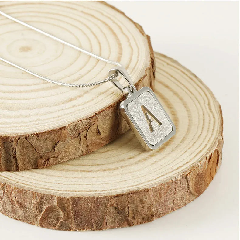 Alphabet necklace with square hollow-out letter pendant in titanium steel, gold or silver electroplated small snake chain