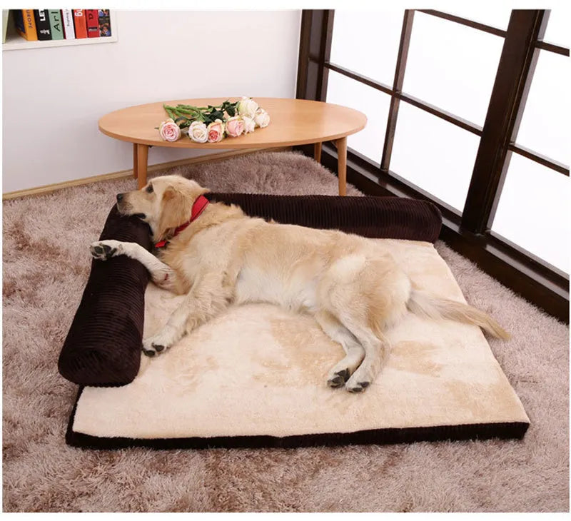 A corduroy dog sofa bed with raised sides in a grey colour, shown on a wooden floor.