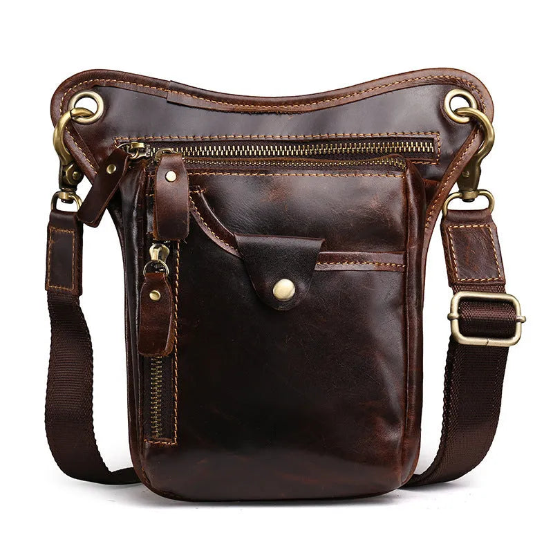 Men's brown Crazy Horse leather retro satchel bag with flap closure on a table.