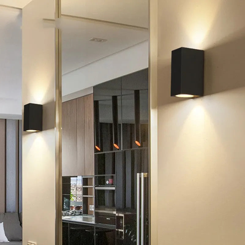 Modern aluminium LED wall lamp in a black finish mounted on a wall.