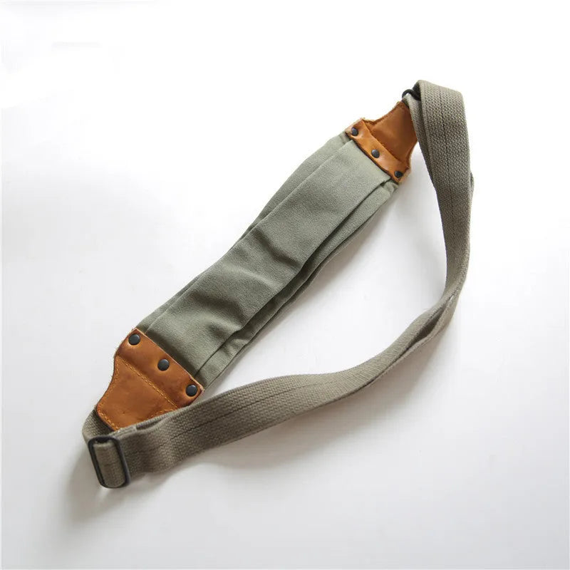 Green military style chest bag with washed canvas exterior and brown Italian leather accents