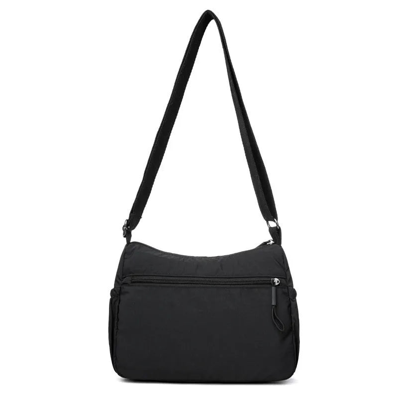 Water-repellent nylon crossbody bag with three-dimensional pocket in black, grey or red