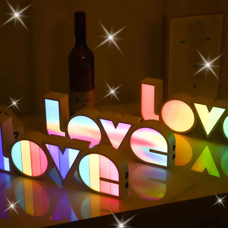 Rainbow style LED Love light for Valentines Day and wedding decoration on a table.