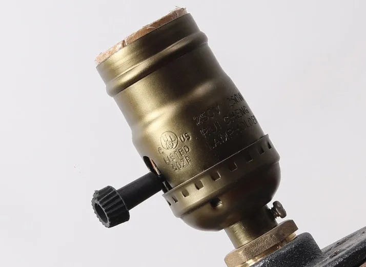 Compact wooden and iron water pipe style table lamp on a surface