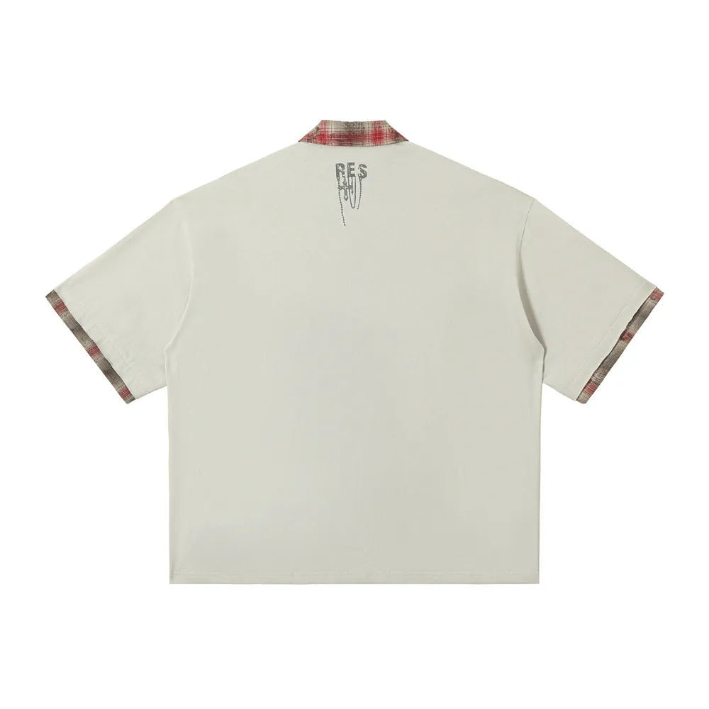 Men's loose blue short-sleeved top with asymmetric cut and graffiti print on the lapel.