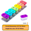 White and rainbow coloured large plastic pill box with 14 removable compartments next to detached single grid.