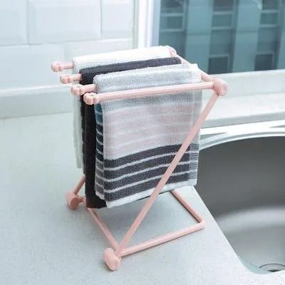 Foldable plastic dishcloth shelf organiser in light blue mounted on wall