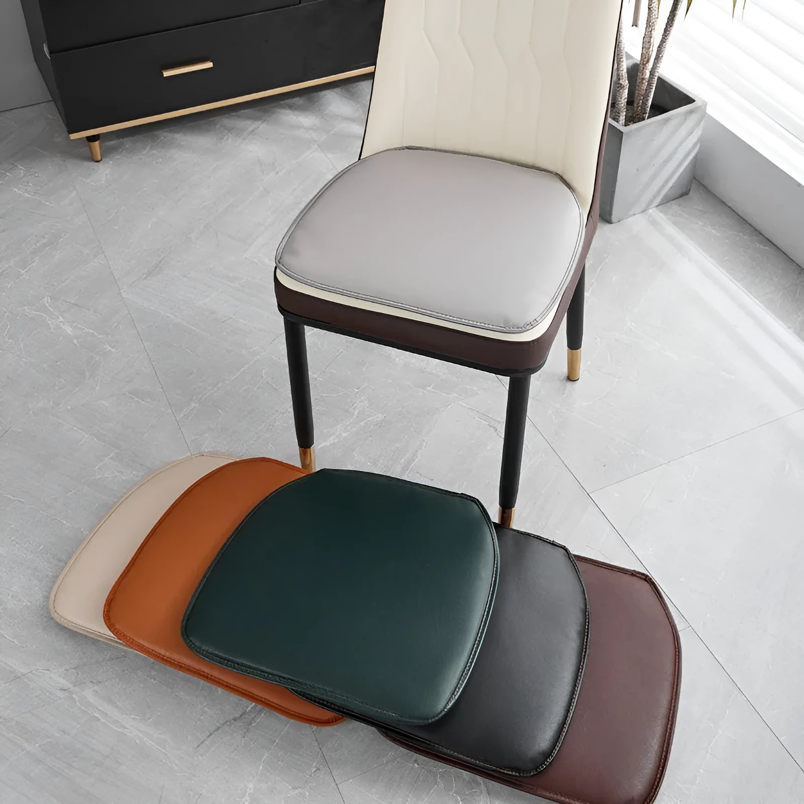 Orange leather horseshoe-shaped seat cushion with non-slip base shown on a wooden chair.