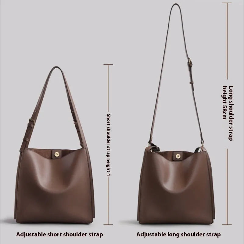 Brown genuine leather women's bucket bag with double shoulder straps and internal compartments.
