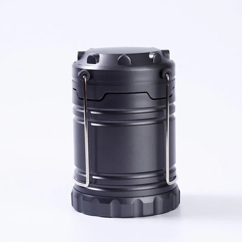 COB LED camping lamp in black with telescopic body and hook, standing on a wooden surface