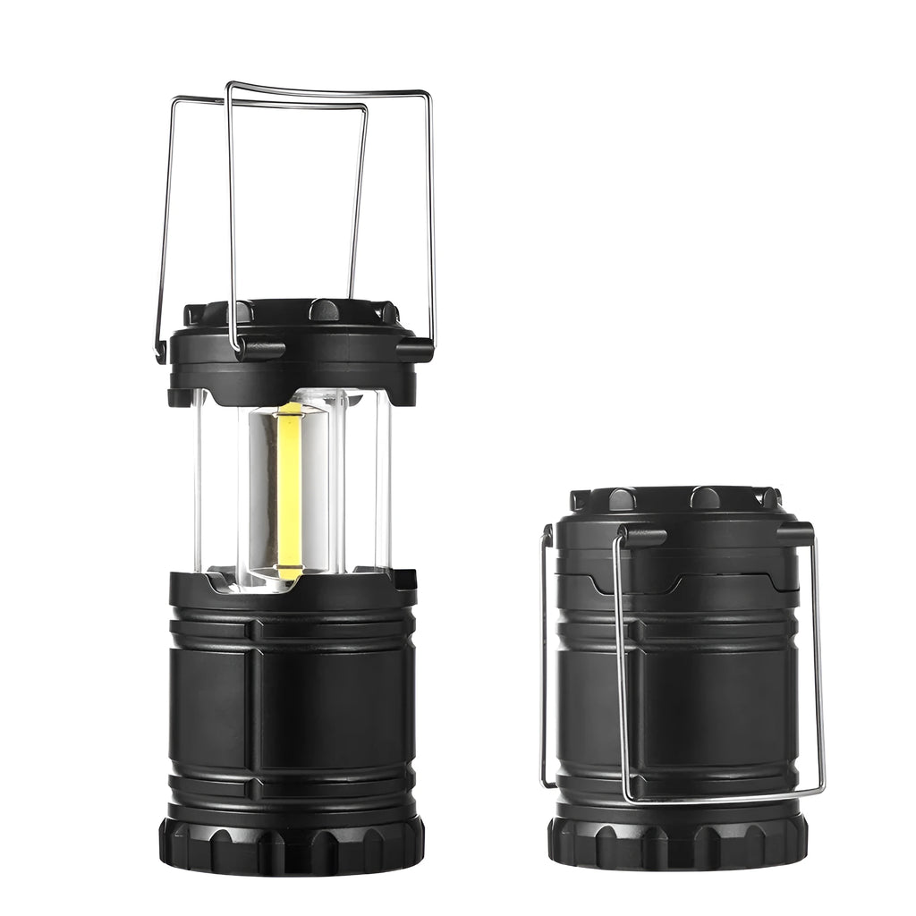 COB LED camping lamp in black with telescopic body and hook, standing on a wooden surface