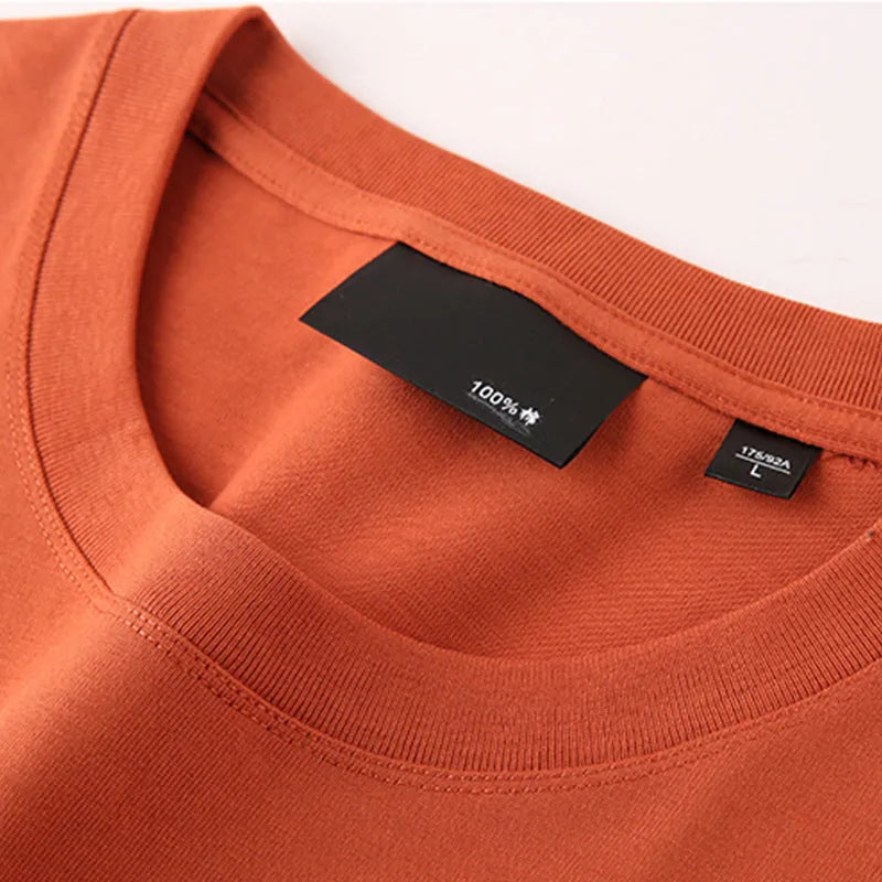 Solid colour round neck casual shirt with drop-shoulder sleeves, shown in a loose fit on a model.