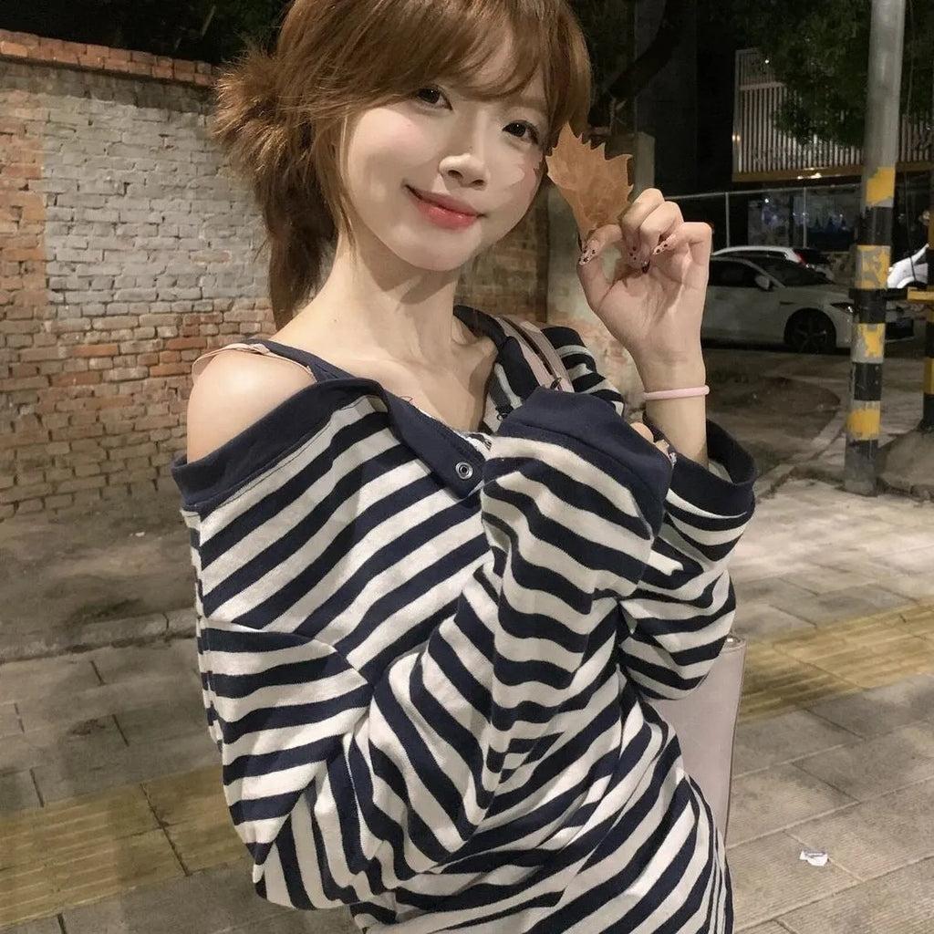 Dark blue Korean-style oversized women's long-sleeved t-shirt with stripes, buttons, and embroidery detail.