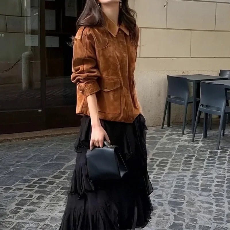 Women's brown suede coat with regular sleeves on a hanger.