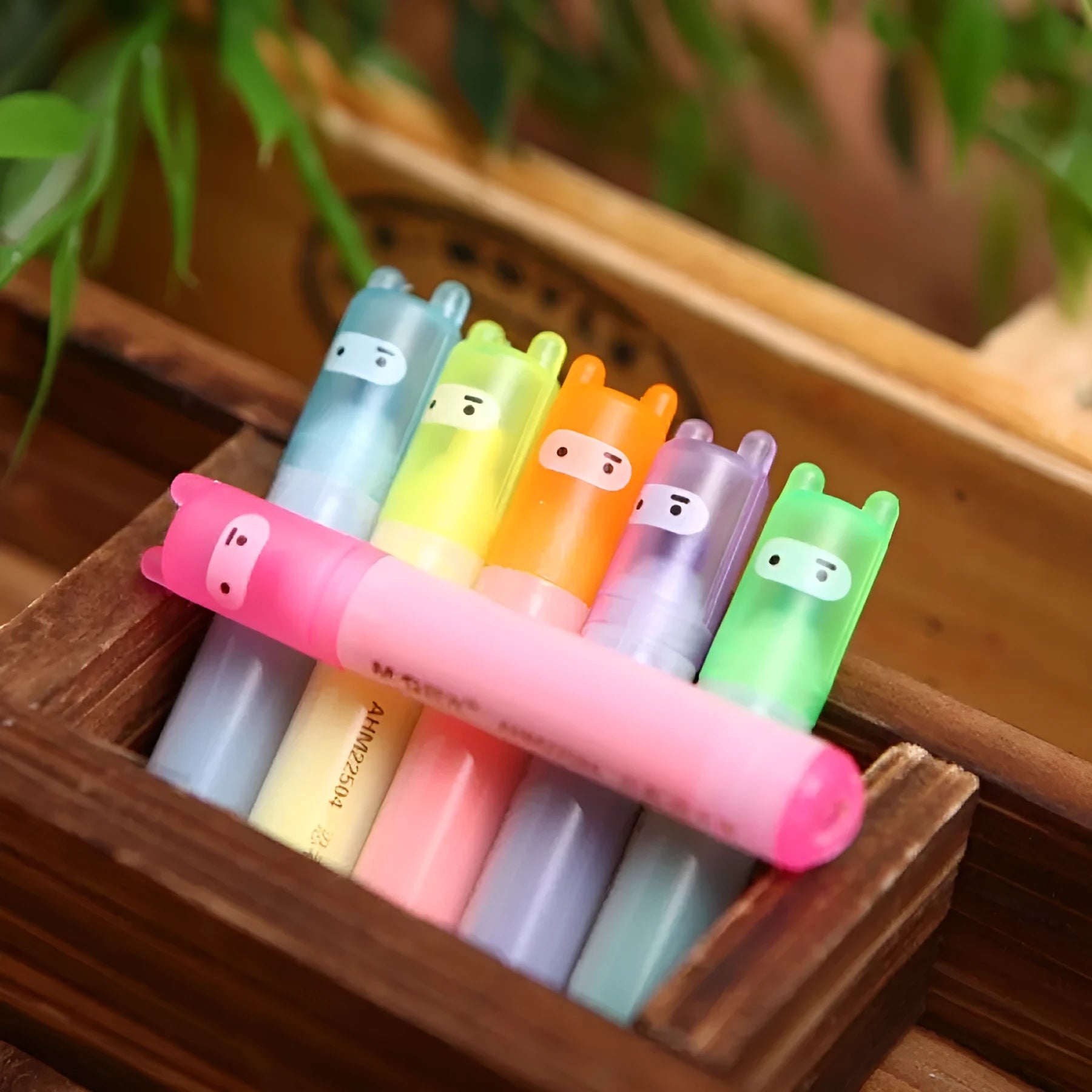 Set of six plastic barrel highlighter pens with chisel tips in six different colours, showing oblique pen shape.