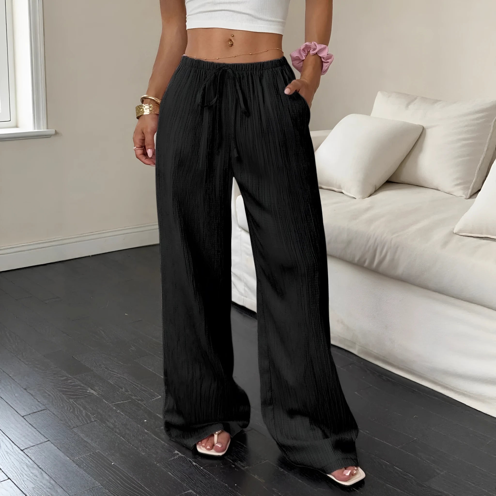 Women's wide-leg black trousers with a lace-up detail on the mid-rise waist