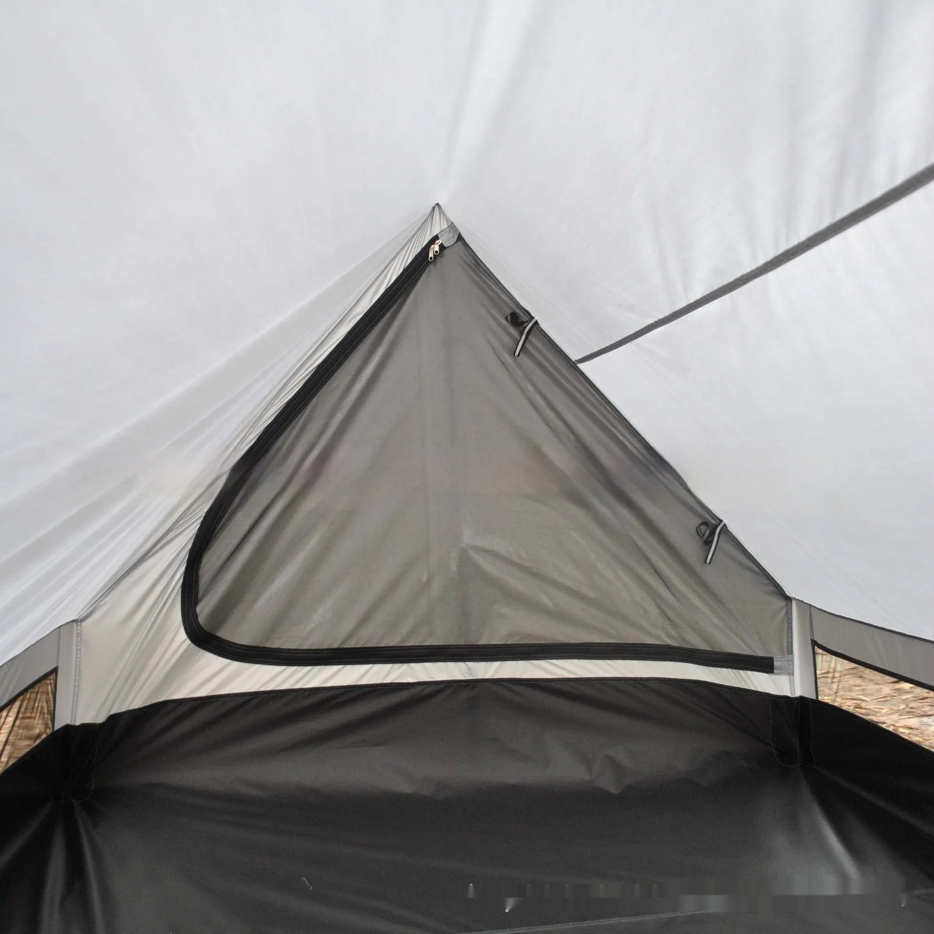Brown A-line pole-free tent erected with hiking canes showing 2-3 person capacity and waterproof fabric construction