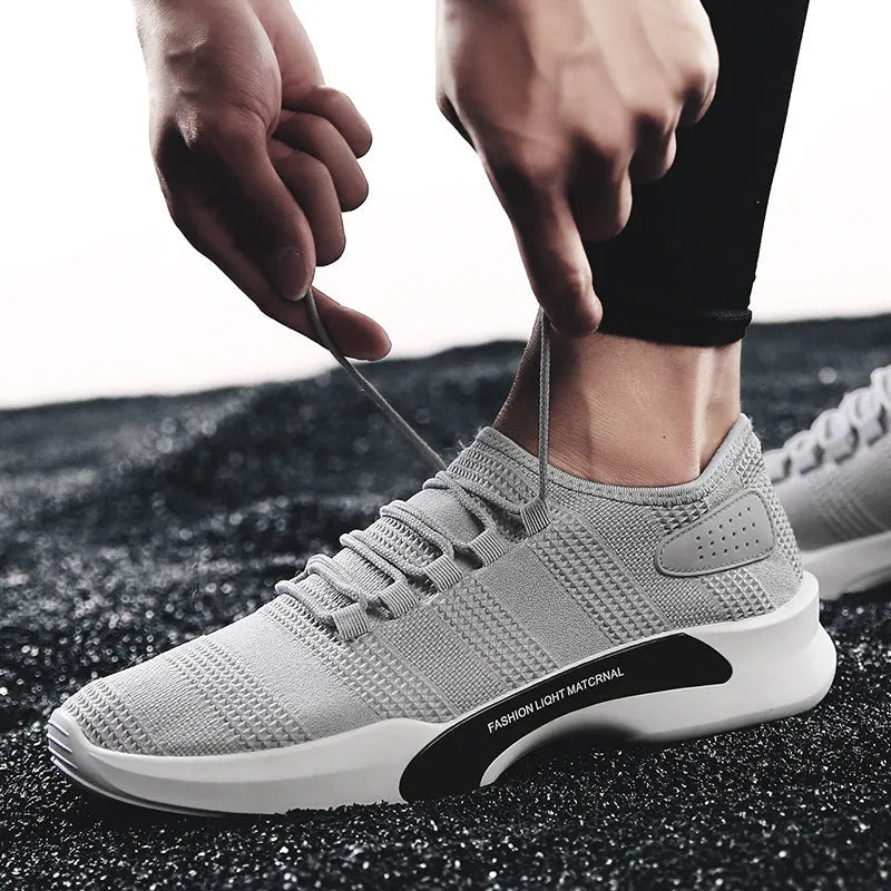 Men's breathable mesh casual sports shoes with front tie, low heel, round toe, in black, grey or white.