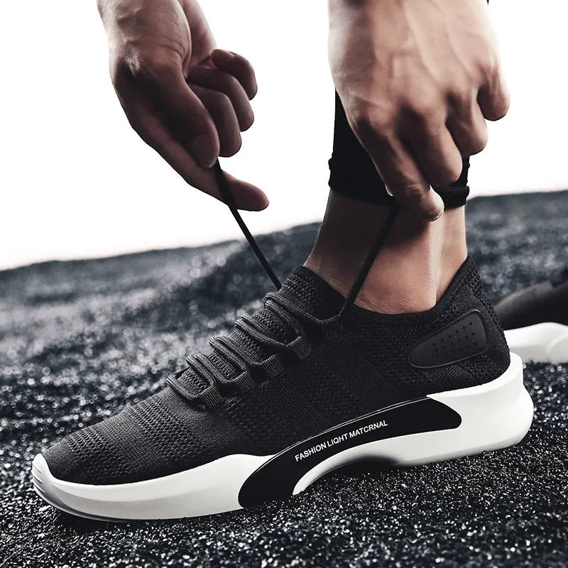 Men's breathable mesh casual sports shoes with front tie, low heel, round toe, in black, grey or white.