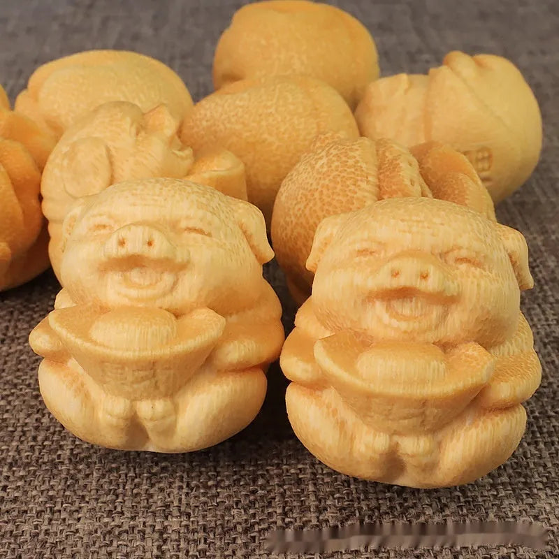 Solid bamboo carving ornament of cute pig figure measuring 4cm tall by 3.5cm diameter