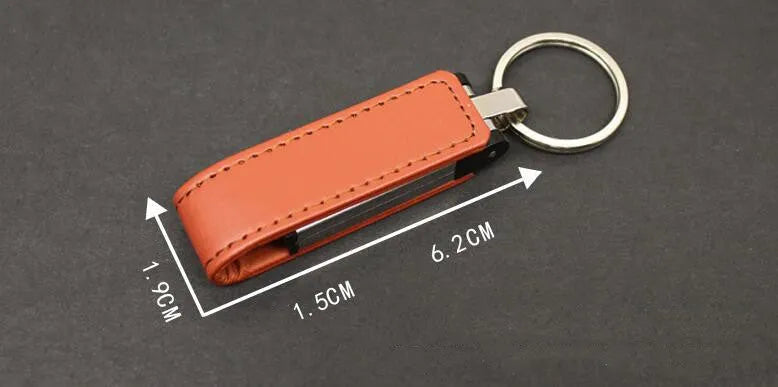 Leather USB 2.0 flash drive keychain in brown with keyring attachment on a white background
