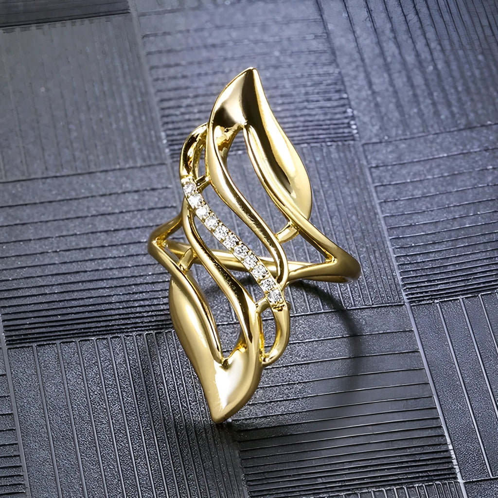 Women's gold-colour ring with exaggerated curved design on finger, showing profile and zircon finish