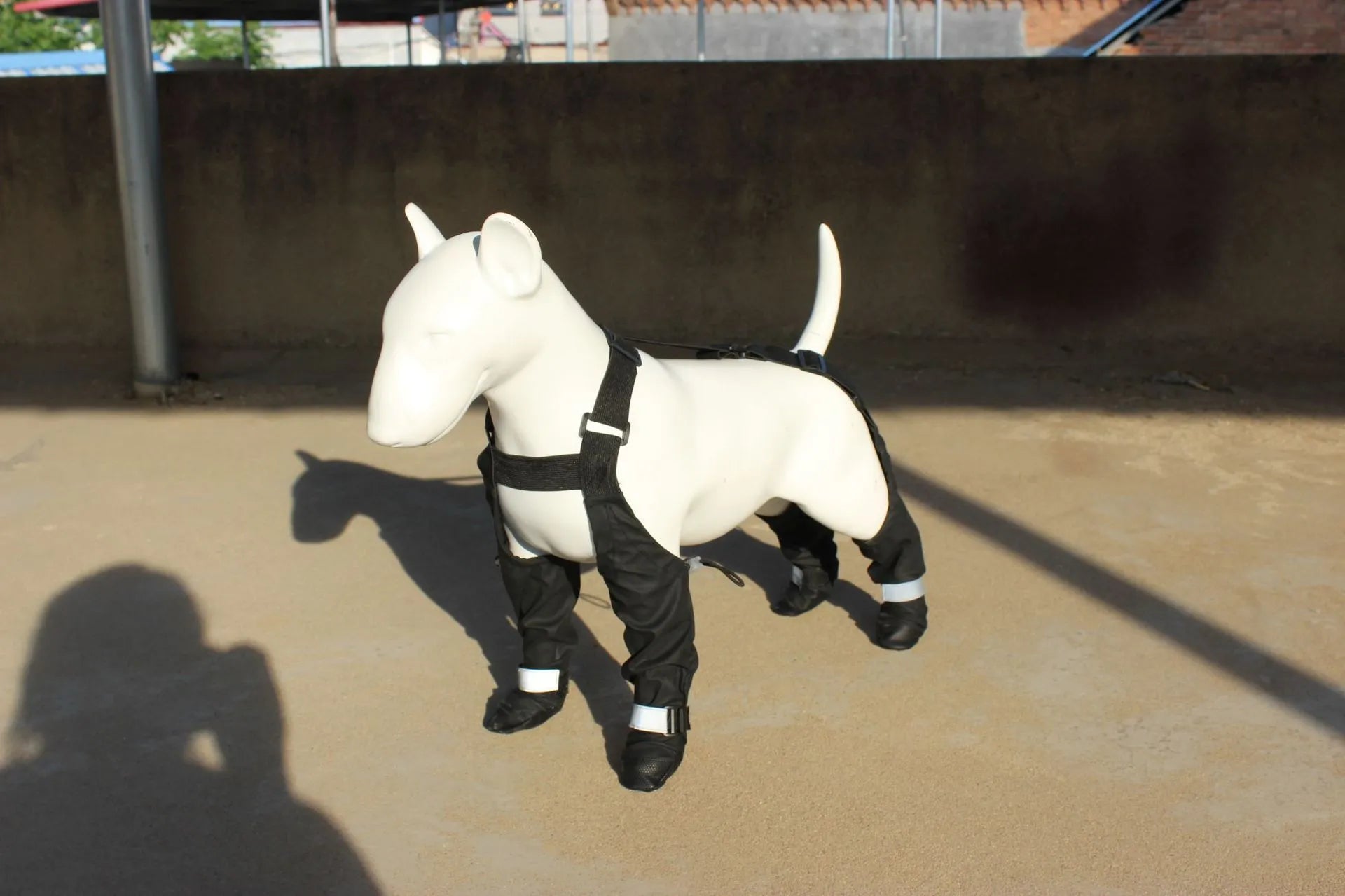Black dog shoes with adjustable ankle straps, set of four waterproof paw protectors.