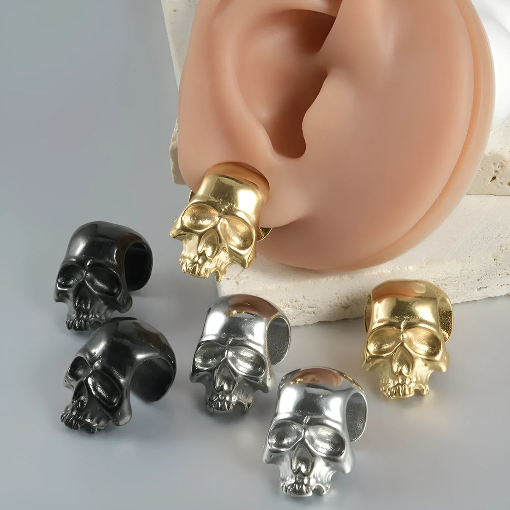 Stainless steel hollow skull and Buddha head earrings in hip hop style.