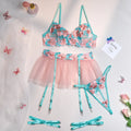 Pink embroidered women's bikini set with a matching mesh pettiskirt laid flat.