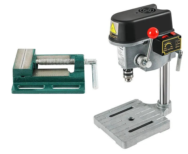 Mini bench drill and milling machine on a workbench with bench pliers.