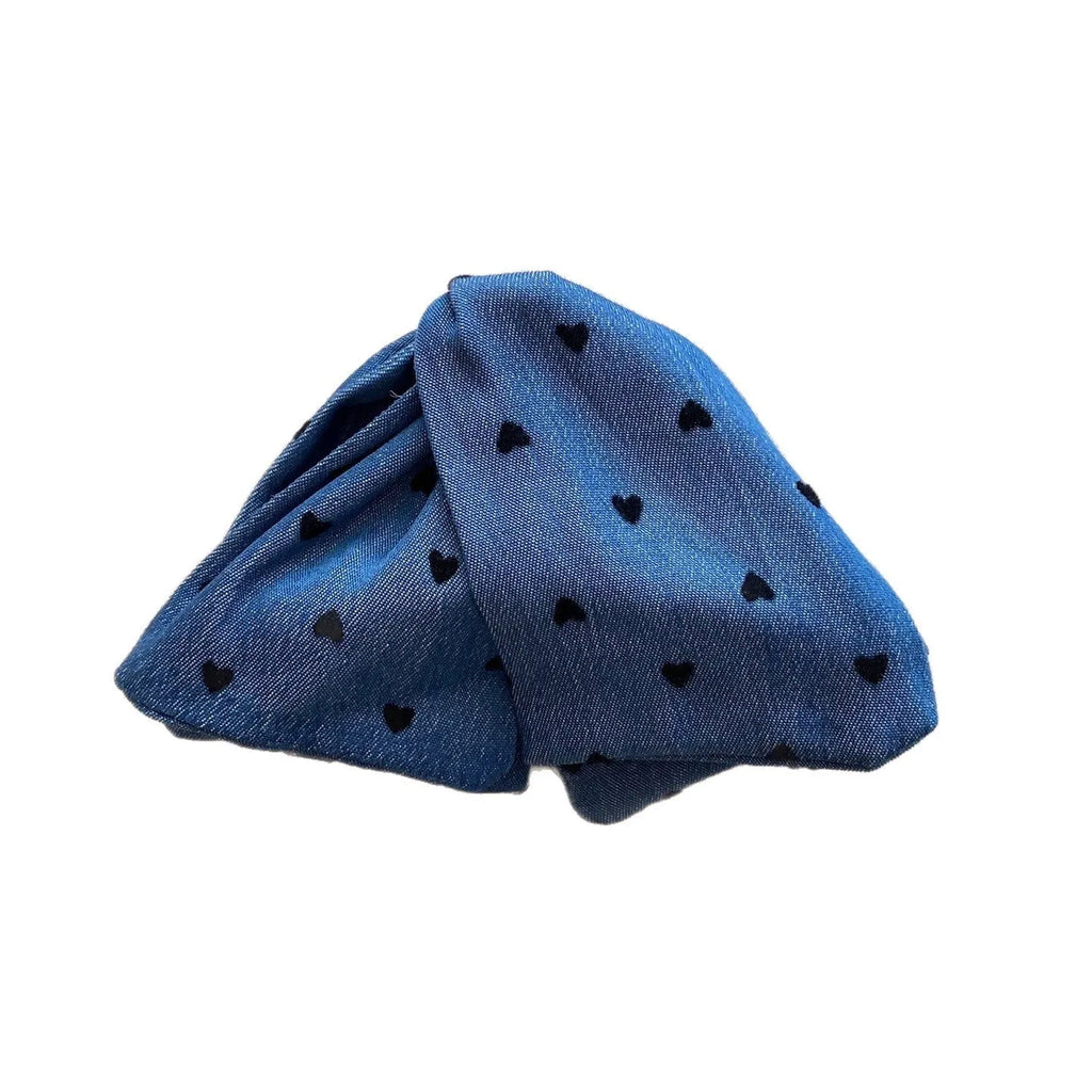 Handmade triangle-shaped hair clip for women in fabric and acrylic, showing plastic grip.