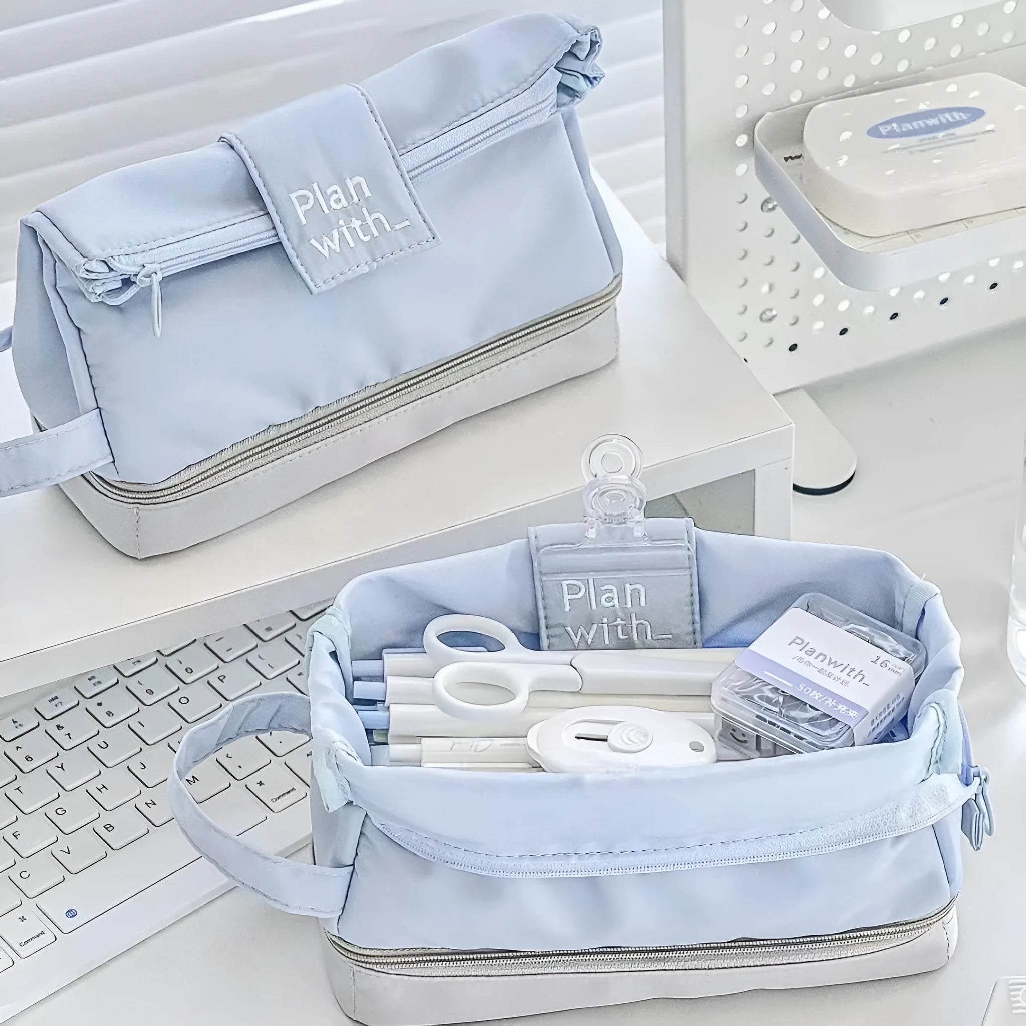 Folding double layer student pencil case in navy blue, blue, and cream white colours made from polyester.
