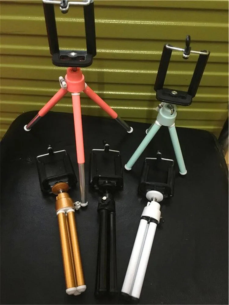 Black desktop phone holder with adjustable two-section bracket supporting smartphone