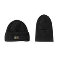 Vintage knitted melon skin warm beanie in black with patch detail on model wearing street-style outfit