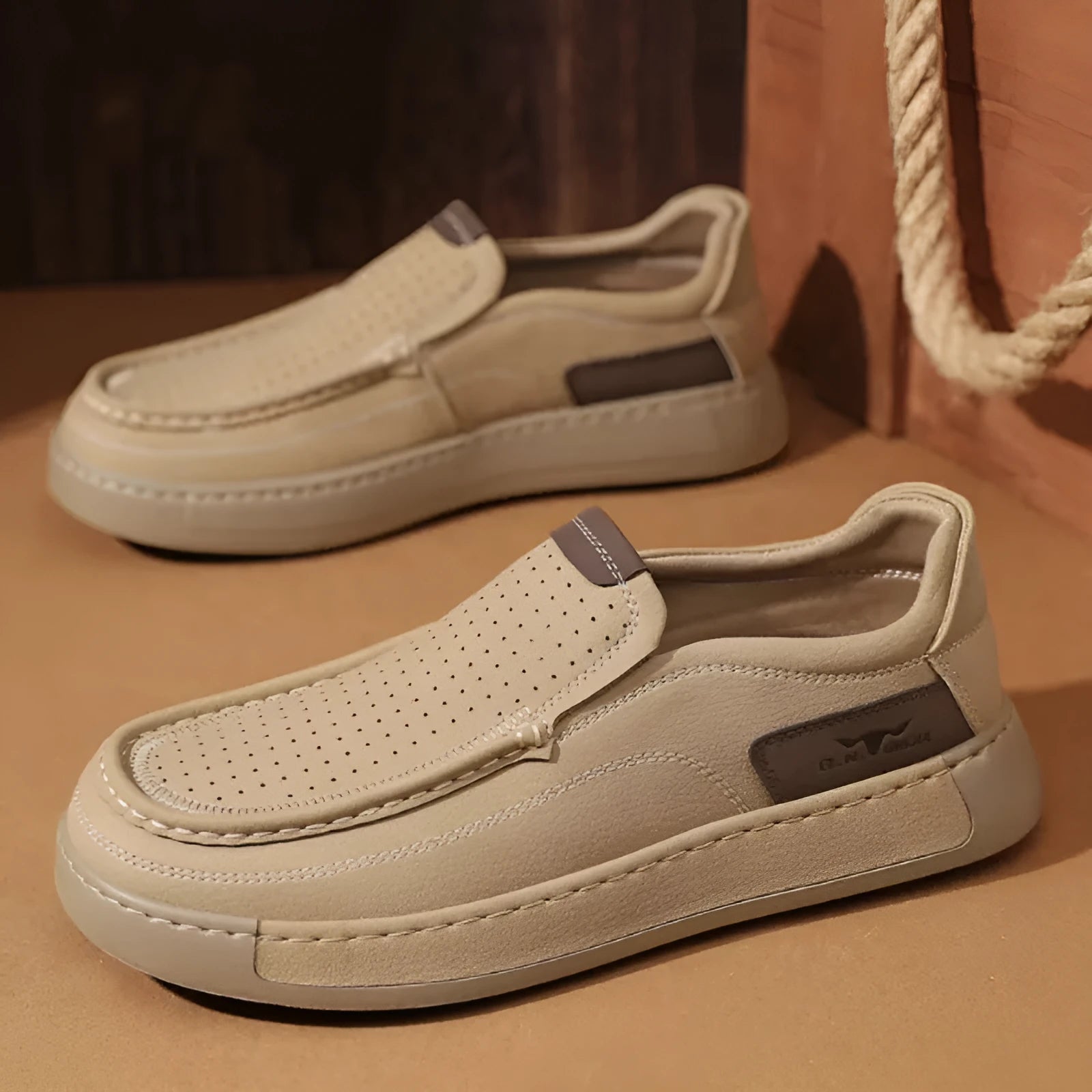 Men's breathable hollow leather slip-on casual shoes in black, side view