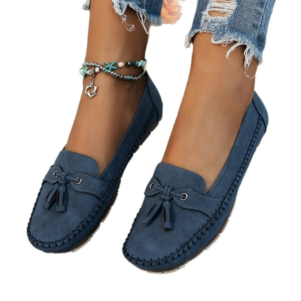 Women's apricot suede flat shoes with a bow detail on the front, showing round toe and low-top design.