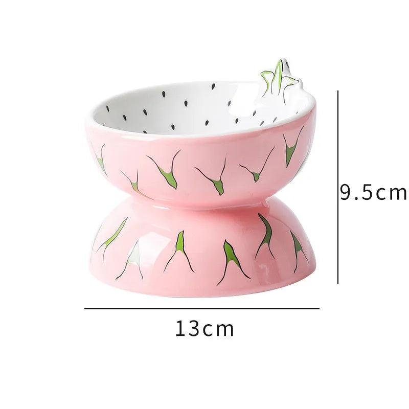 Ceramic elevated cat bowl with tilted wide dish in a colourful fruit pattern.