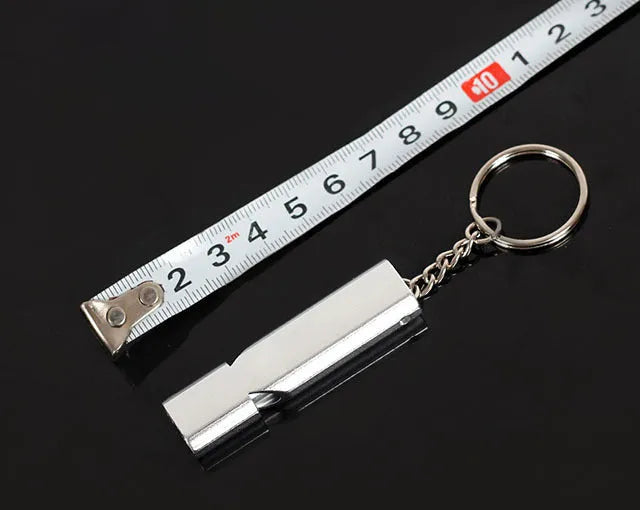 Gold and silver aluminium alloy double-hole survival whistle on a keyring.