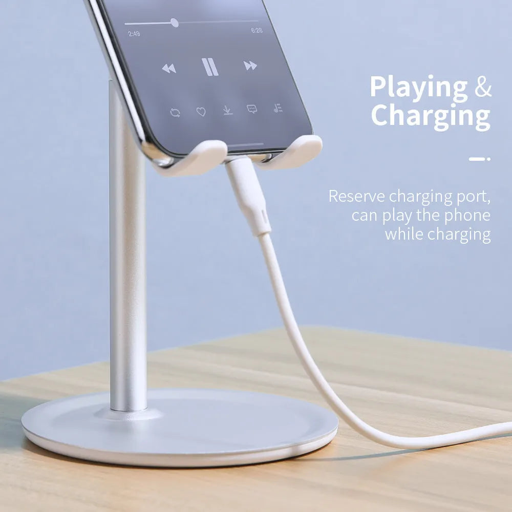 Silver white aluminium alloy mobile phone stand holding a smartphone on a desk