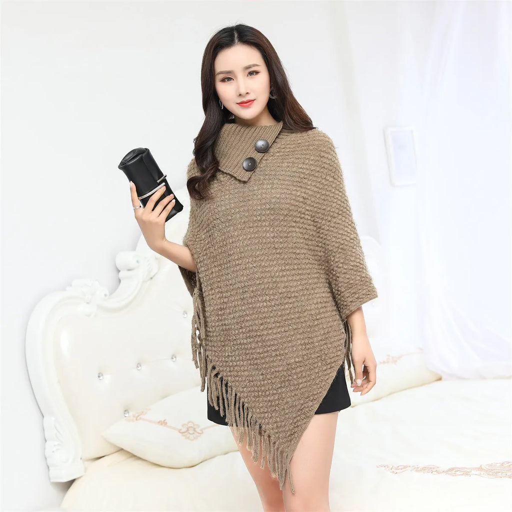 Dotted pattern sleeveless knitted cloak shawl in acrylic fibre, shown in apricot colour.
