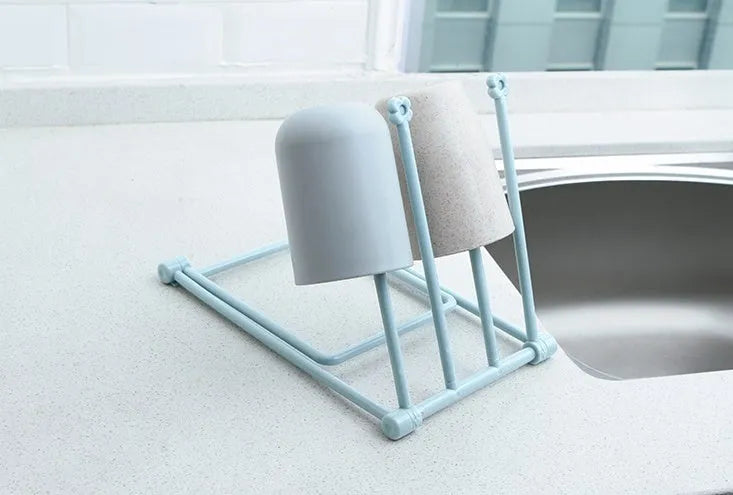 Foldable plastic dishcloth shelf organiser in light blue mounted on wall