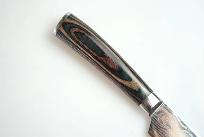 Kitchen knife set with Damascus pattern blades and coloured wood handles on display