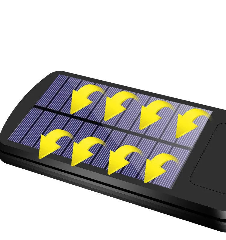 Black solar-powered outdoor security light with motion sensor on a wall
