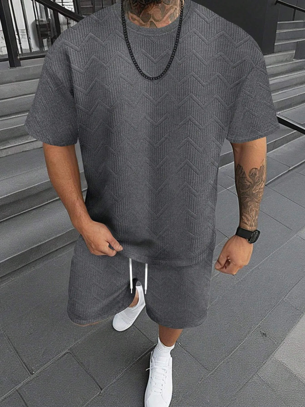 Men's short sleeve top and shorts suit in a printed pattern, shown in a sport leisure style.